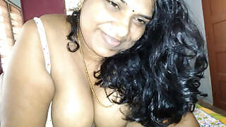 Tamil auntie gives him a titjob and smiles a lot