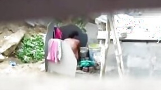 A neighbor on a hidden camera filmed his aunt taking a bath outdoors naked