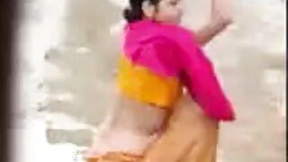 Bhabhi bathes in the open air, secretly captured by a neighbor
