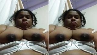 A horny NRI Bhabhi Plays with her tits on camera